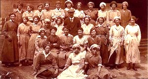 'Polly' Atkin, wife of Charles Alfred Atkin, working at the Clay Pipe Works, far left, hand in apron pocket